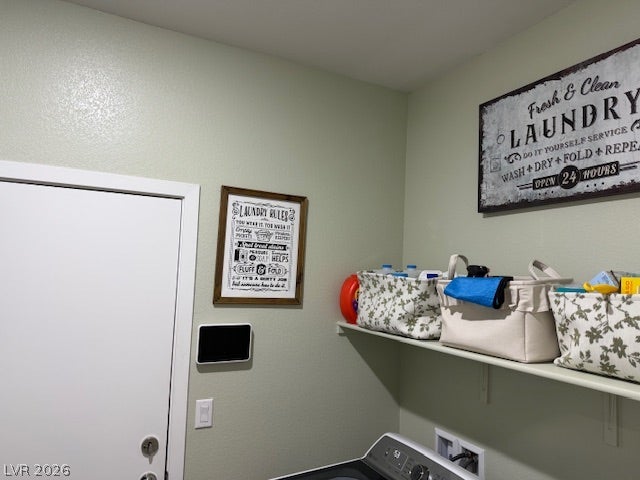384 Aravalli Crest Street, Henderson, NV 89015 Functional laundry space featuring a practical shelf for organization, ideal for daily chores.