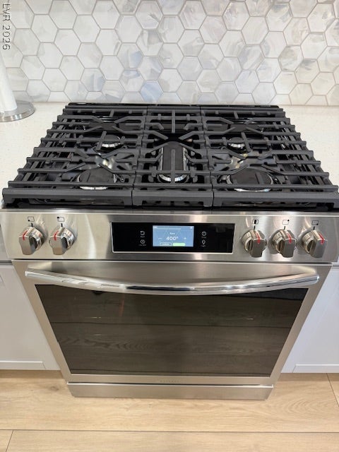 384 Aravalli Crest Street, Henderson, NV 89015 Culinary delights await with this stainless steel range, featuring a gas cooktop and a modern design.