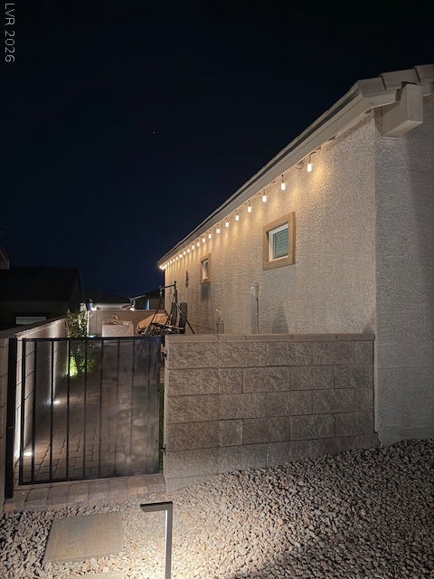 384 Aravalli Crest Street, Henderson, NV 89015 Illuminated soffits and stone pathways create an inviting evening entry.