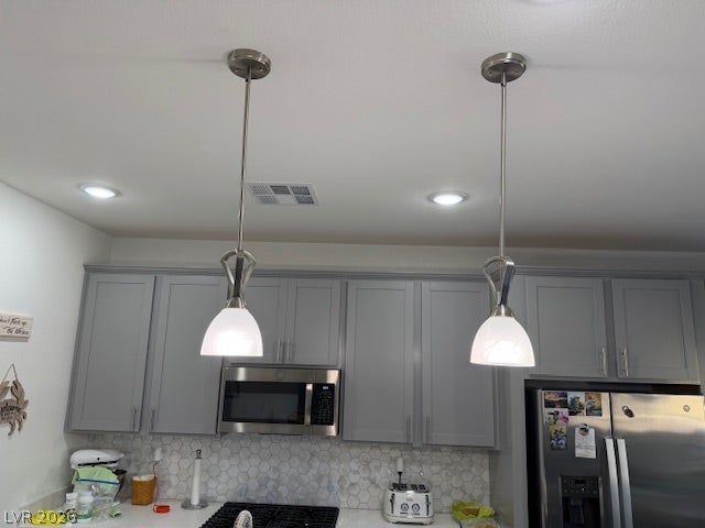 384 Aravalli Crest Street, Henderson, NV 89015 Illuminating pendant lighting graces this well-appointed kitchen, featuring modern appliances and ample cabinetry.