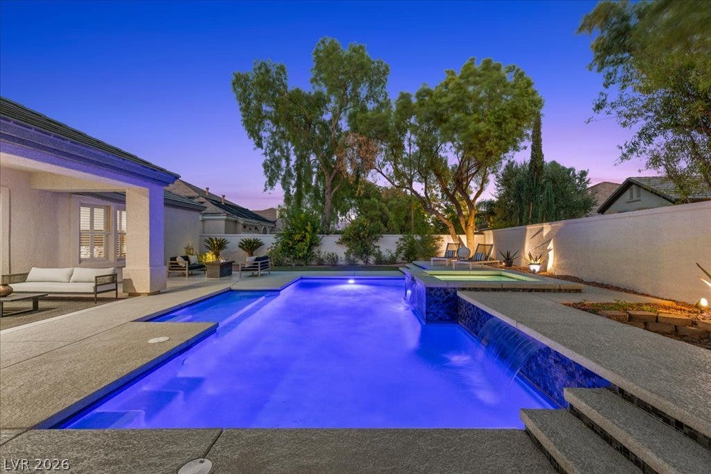 9425 Garnet Crown Avenue, Las Vegas, NV 89145 Mature trees frame a sparkling pool with a water feature and integrated spa.