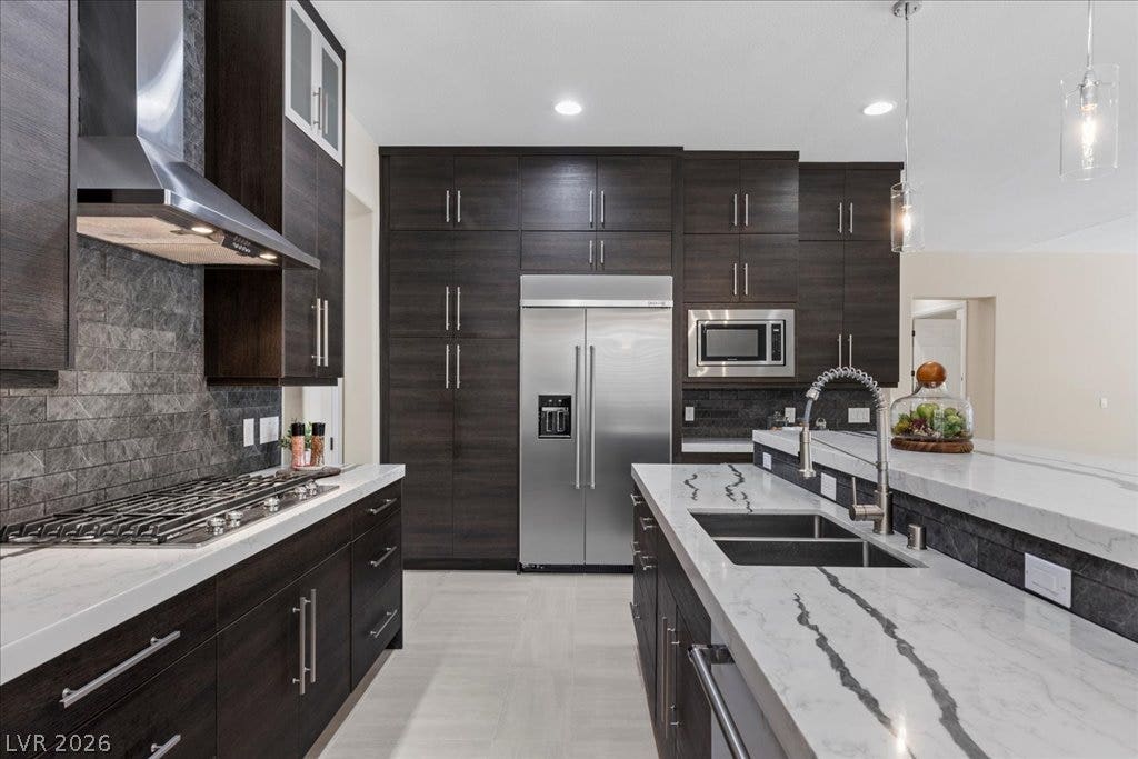 9425 Garnet Crown Avenue, Las Vegas, NV 89145 Gleaming stone countertops and dark cabinetry create a modern culinary workspace.