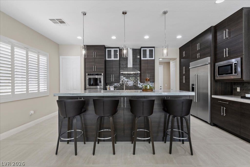 9425 Garnet Crown Avenue, Las Vegas, NV 89145 Sleek dark cabinetry and stone countertops anchor this modern culinary space.