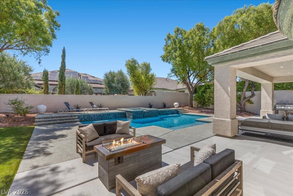 9425 Garnet Crown Avenue, Las Vegas, NV 89145 A sparkling swimming pool anchors the backyard retreat, overlooked by a sheltered patio structure.