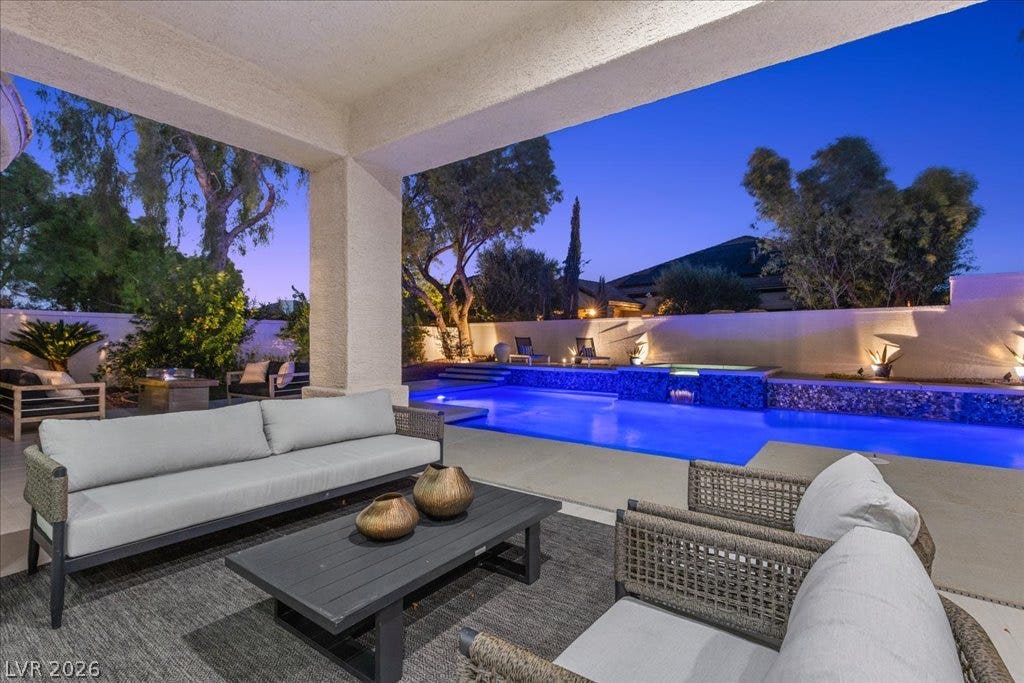 9425 Garnet Crown Avenue, Las Vegas, NV 89145 An inviting covered patio opens directly to the custom pool and manicured outdoor living space.