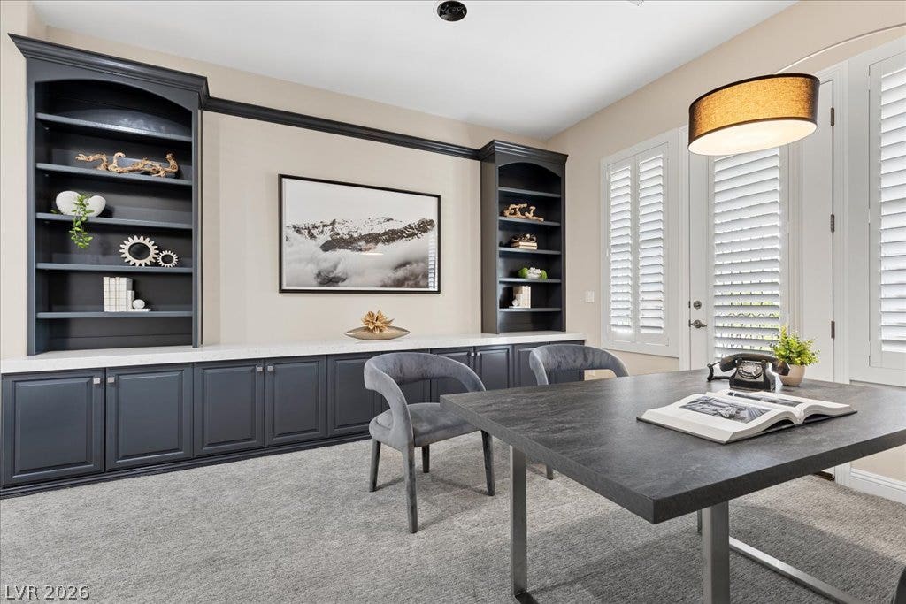 9425 Garnet Crown Avenue, Las Vegas, NV 89145 Custom built-in cabinetry and soft carpeting define this quiet home office space.