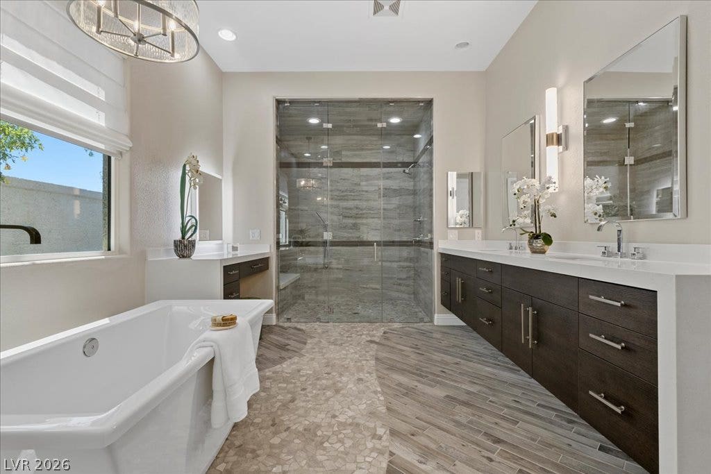 9425 Garnet Crown Avenue, Las Vegas, NV 89145 Custom tile work and a freestanding tub define this luxurious primary bathroom.