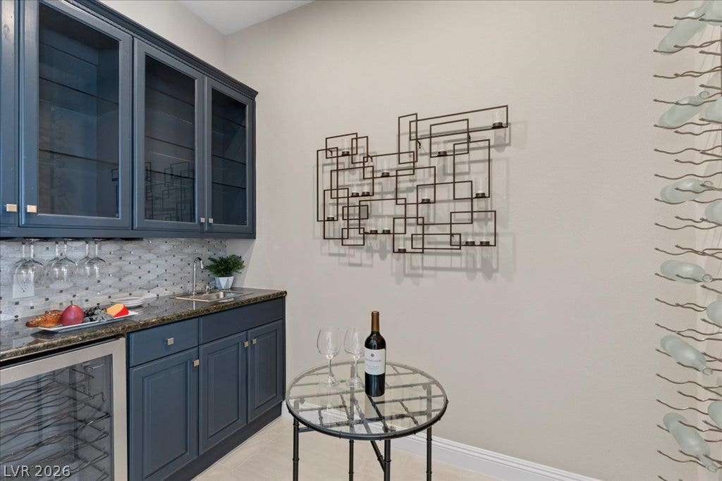 9425 Garnet Crown Avenue, Las Vegas, NV 89145 Tailored cabinetry and stone countertops elevate this elegant home beverage station.