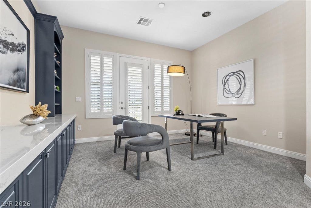 9425 Garnet Crown Avenue, Las Vegas, NV 89145 Elegant built-in cabinetry and soft carpeting define this versatile home office workspace.