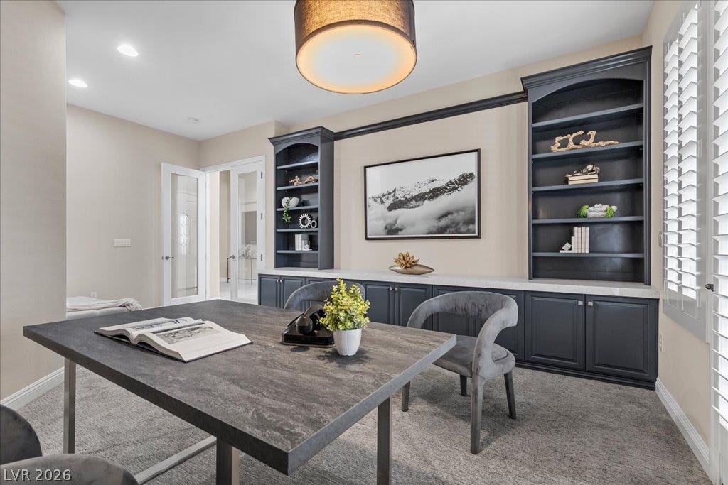 9425 Garnet Crown Avenue, Las Vegas, NV 89145 Custom built-in shelving and soft recessed lighting define this elegant home workspace.
