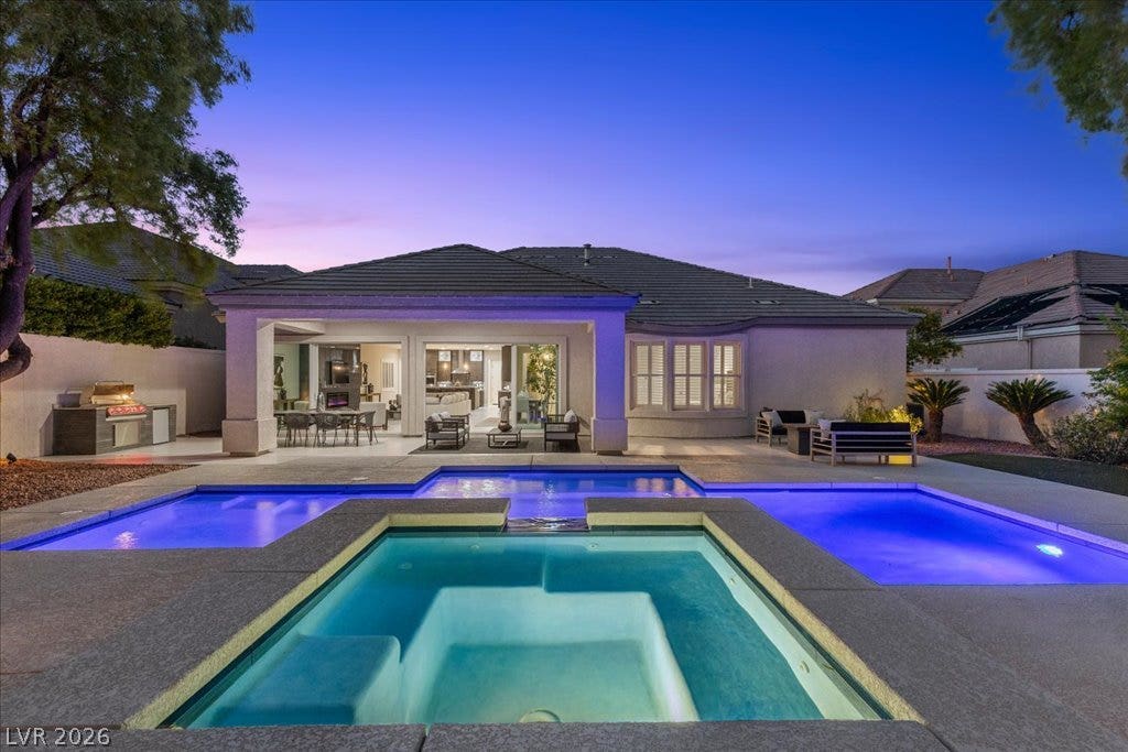 9425 Garnet Crown Avenue, Las Vegas, NV 89145 A pristine pool and integrated spa anchor this backyard oasis set against a tiled roofline.