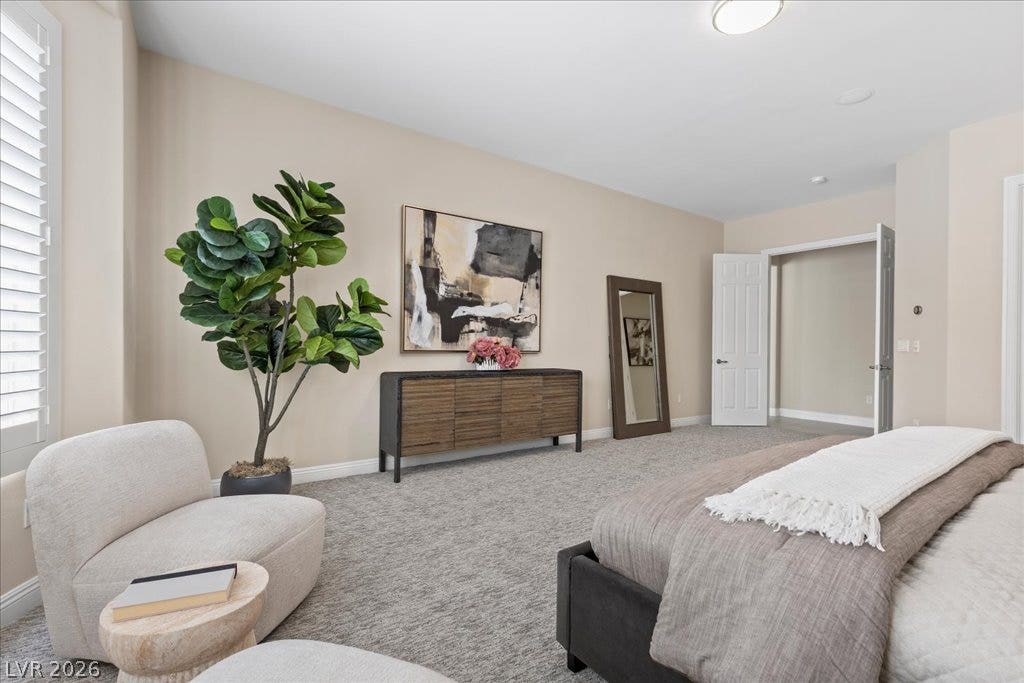9425 Garnet Crown Avenue, Las Vegas, NV 89145 Plush carpeting and plantation shutters define this serene primary suite.