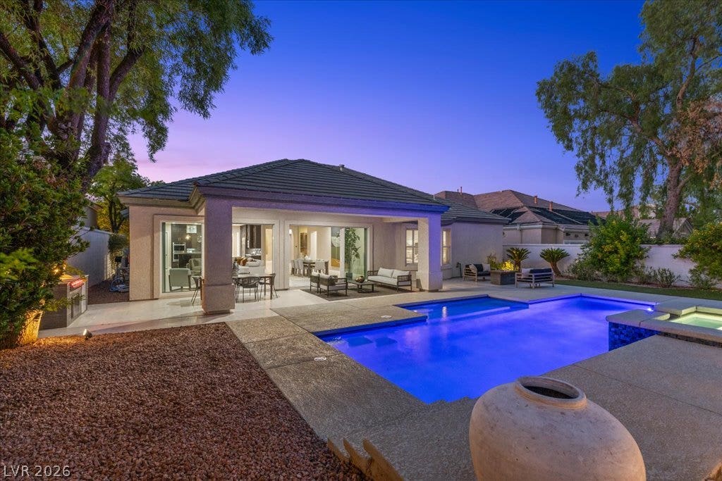 9425 Garnet Crown Avenue, Las Vegas, NV 89145 An inviting backyard features a glistening pool and a spacious covered patio.