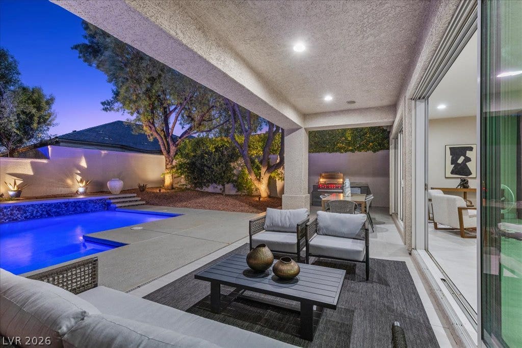 9425 Garnet Crown Avenue, Las Vegas, NV 89145 An inviting covered patio opens directly to a sparkling pool and manicured backyard oasis.