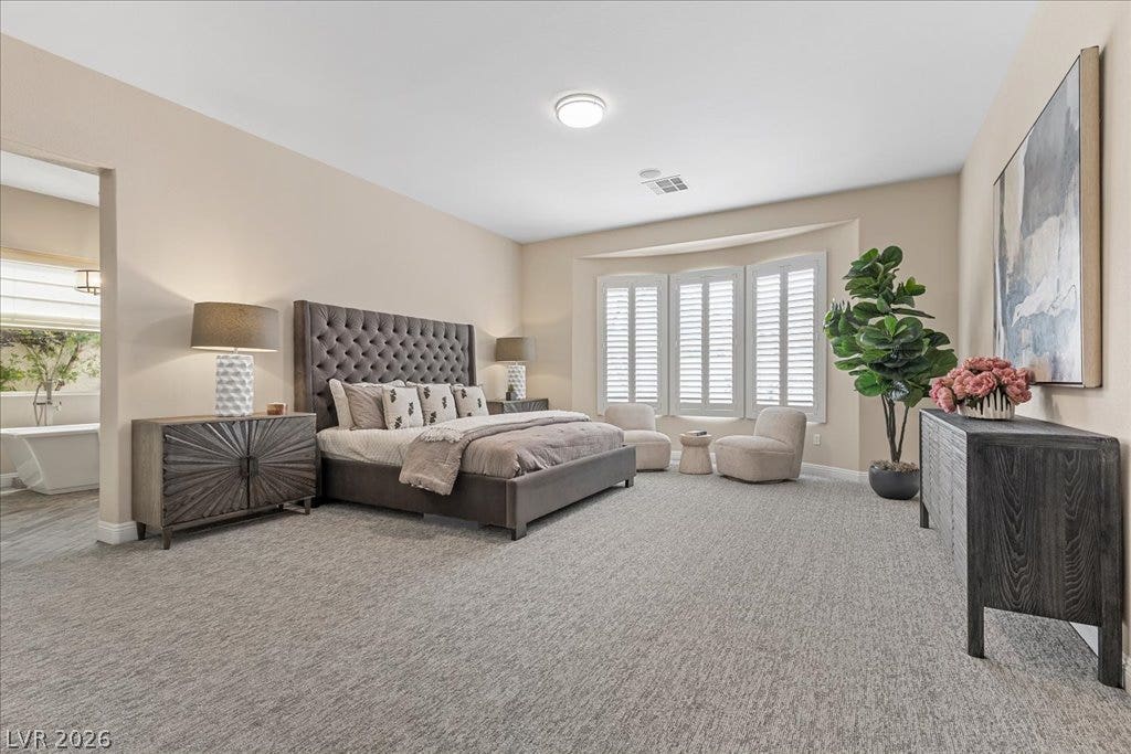 9425 Garnet Crown Avenue, Las Vegas, NV 89145 Plush carpeting and elegant plantation shutters define this serene primary suite retreat.