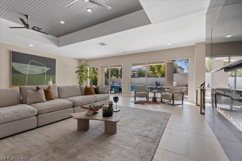 9425 Garnet Crown Avenue, Las Vegas, NV 89145 Sliding glass doors open to the patio from this spacious living area with tile flooring.