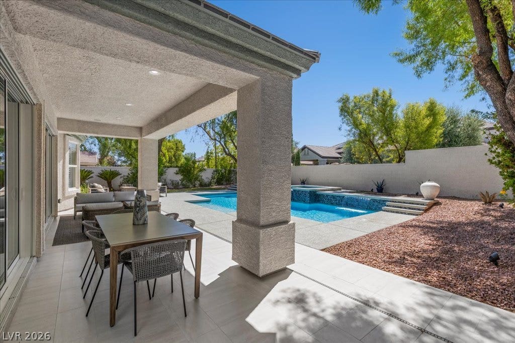 9425 Garnet Crown Avenue, Las Vegas, NV 89145 An inviting covered patio looks out over a sparkling pool and spa in the backyard.