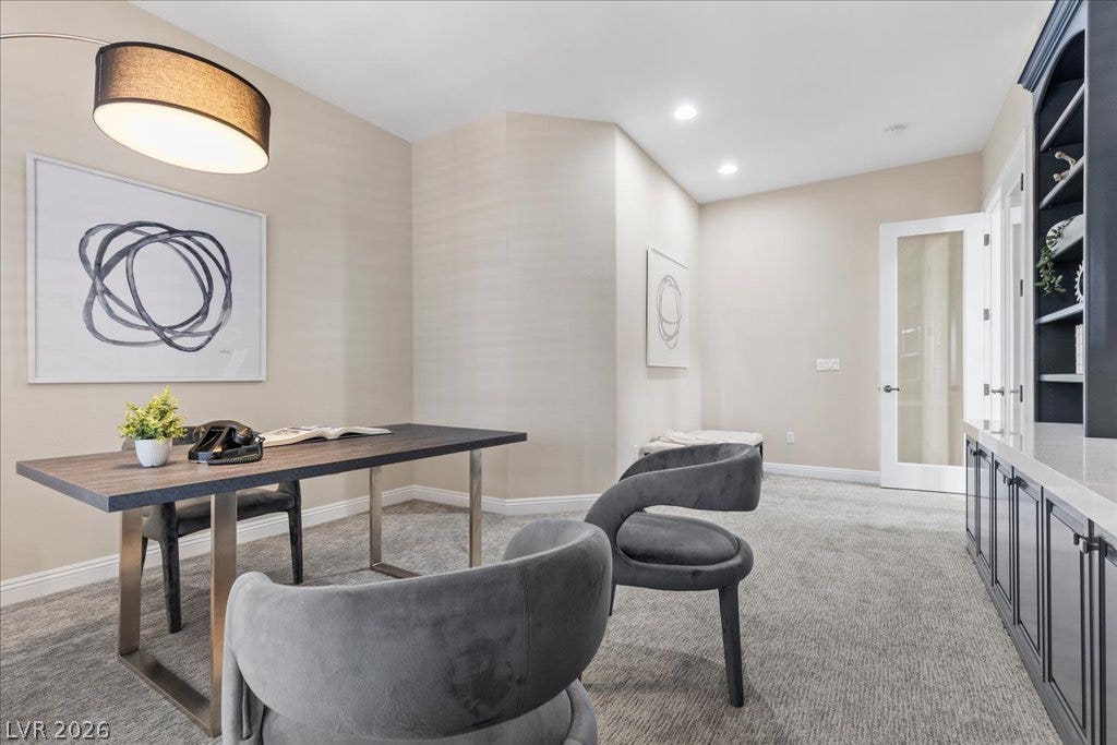 9425 Garnet Crown Avenue, Las Vegas, NV 89145 Recessed lighting, plush carpeting, and built-in cabinetry define this quiet home office space.