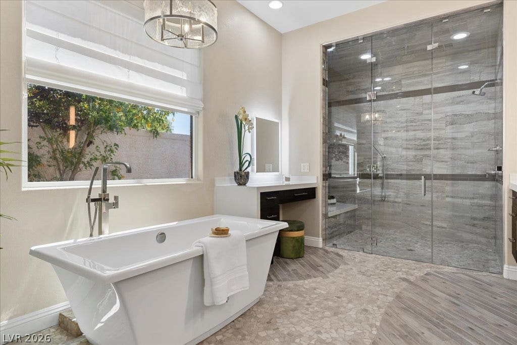 9425 Garnet Crown Avenue, Las Vegas, NV 89145 A freestanding soaking tub sits beside a large walk-in glass shower with custom tile.