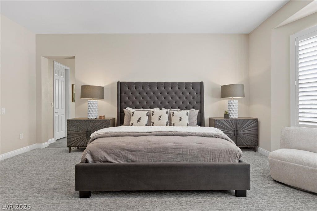 9425 Garnet Crown Avenue, Las Vegas, NV 89145 Plush wall-to-wall carpeting and clean architectural lines define this serene bedroom space.