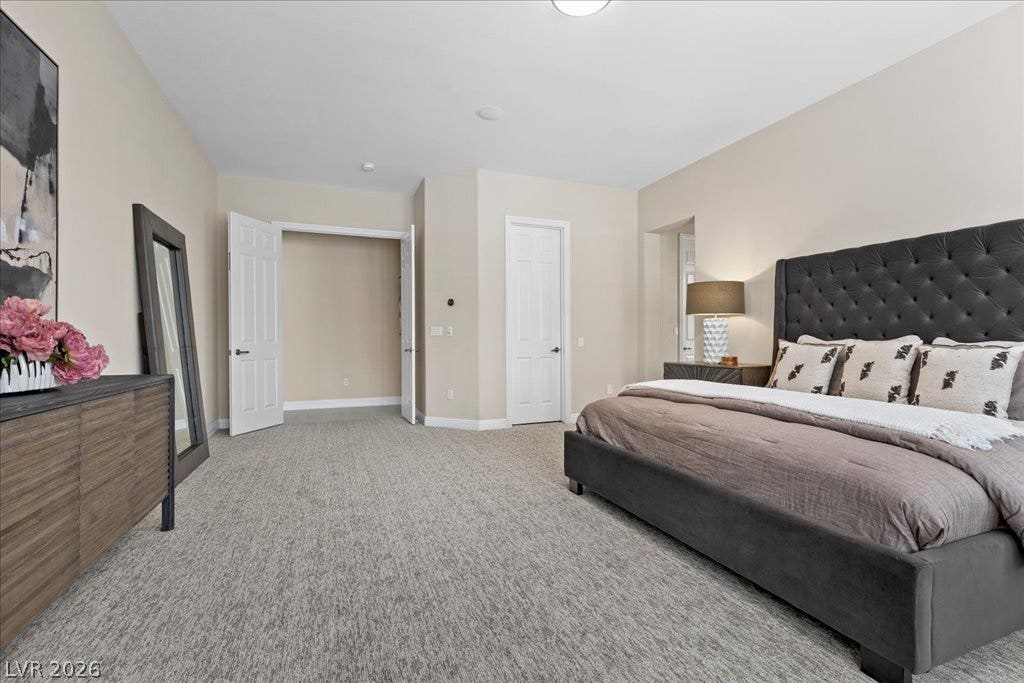9425 Garnet Crown Avenue, Las Vegas, NV 89145 Plush wall-to-wall carpeting and neutral tones define this comfortable, well-proportioned bedroom.