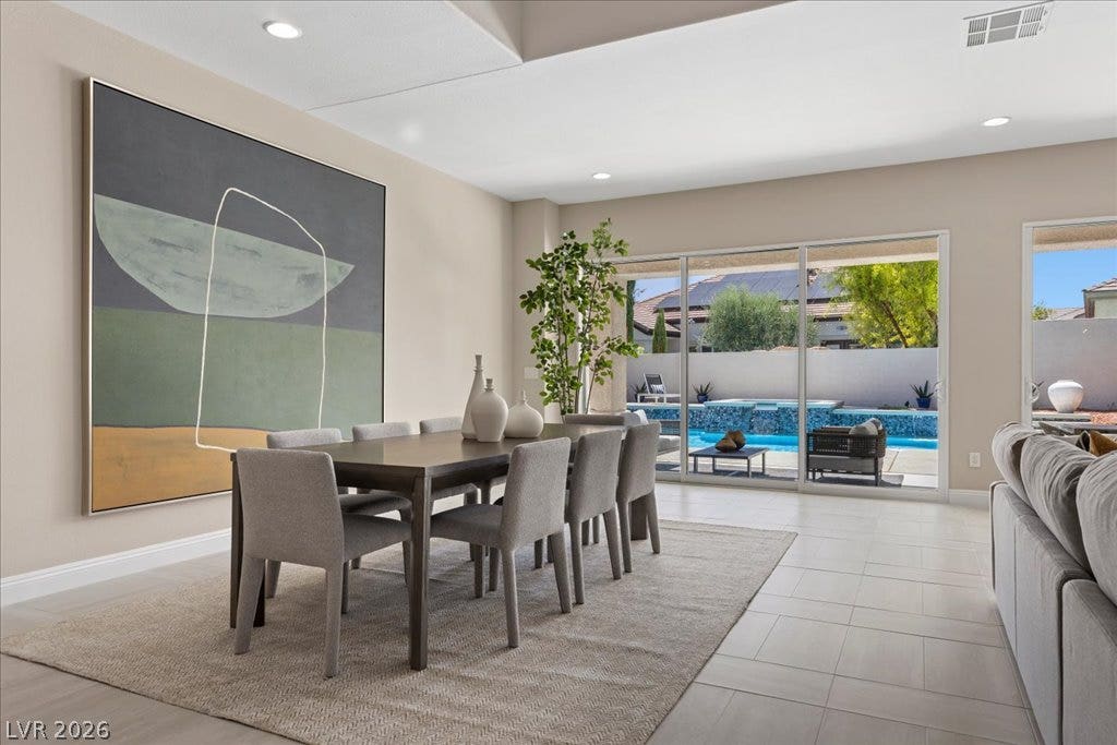 9425 Garnet Crown Avenue, Las Vegas, NV 89145 An open dining area features tiled flooring and large sliding glass doors opening to the pool.