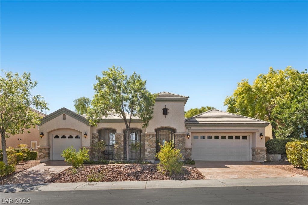 9425 Garnet Crown Avenue, Las Vegas, NV 89145 Stone accents and a tiled roof enhance the elegant exterior of this one-story home.