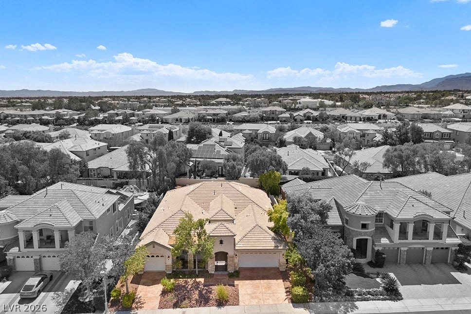 9425 Garnet Crown Avenue, Las Vegas, NV 89145 An aerial perspective showcases the tiled roofline and paved driveway under wide desert skies.