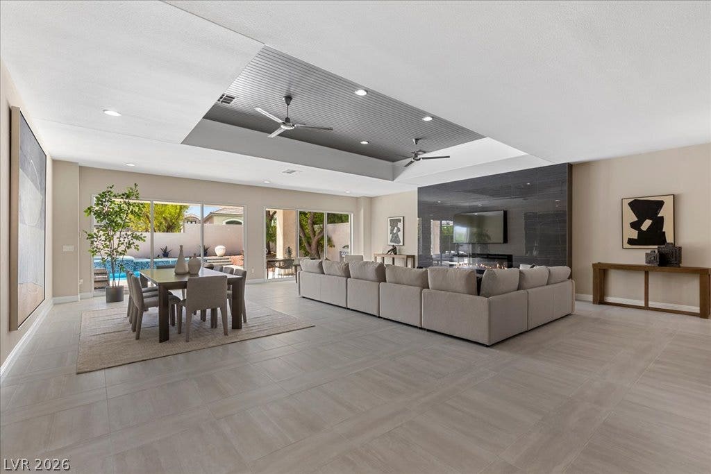 9425 Garnet Crown Avenue, Las Vegas, NV 89145 An open floorplan connects the living and dining spaces under a dynamic recessed ceiling.