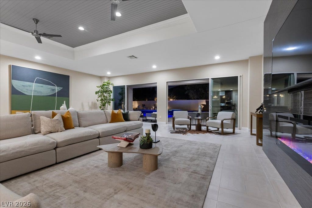 9425 Garnet Crown Avenue, Las Vegas, NV 89145 Sliding glass doors seamlessly connect this modern living area to the outdoor pool terrace.