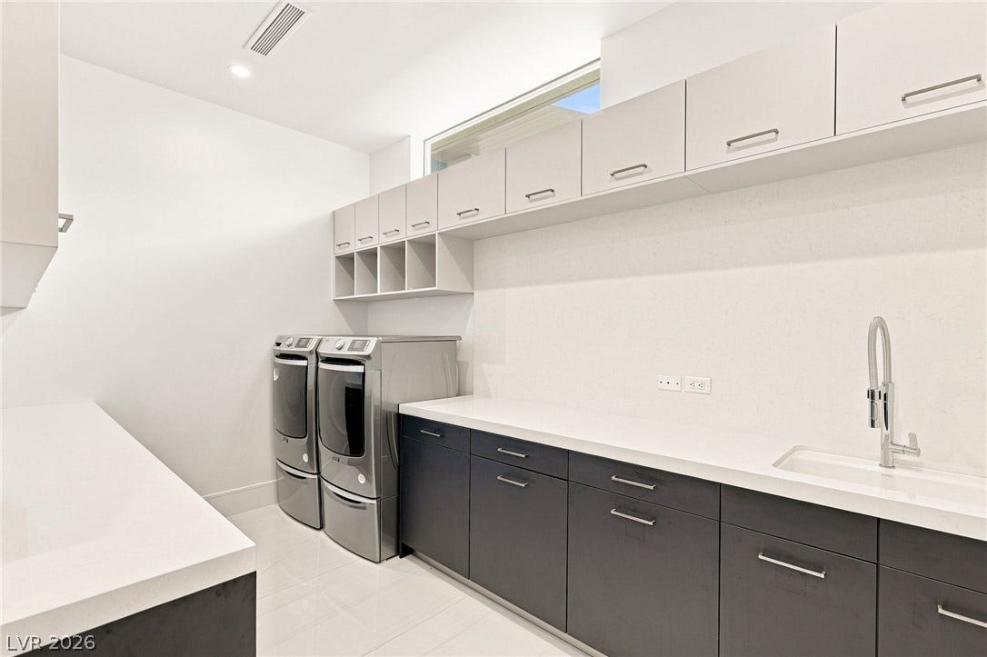 4 Chisel Crest Court, Henderson, NV 89012 Sleek modern cabinetry and ample counter space define this streamlined utility workspace.