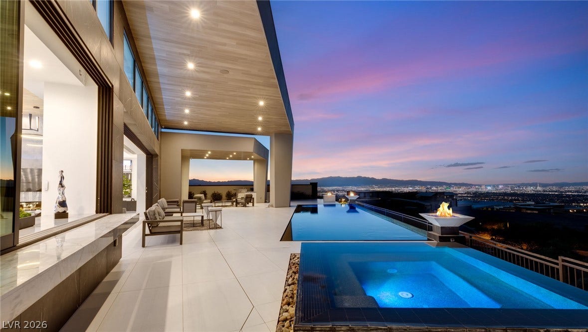 4 Chisel Crest Court, Henderson, NV 89012 An infinity pool and spa overlook sweeping city skyline views from a covered tiled terrace.