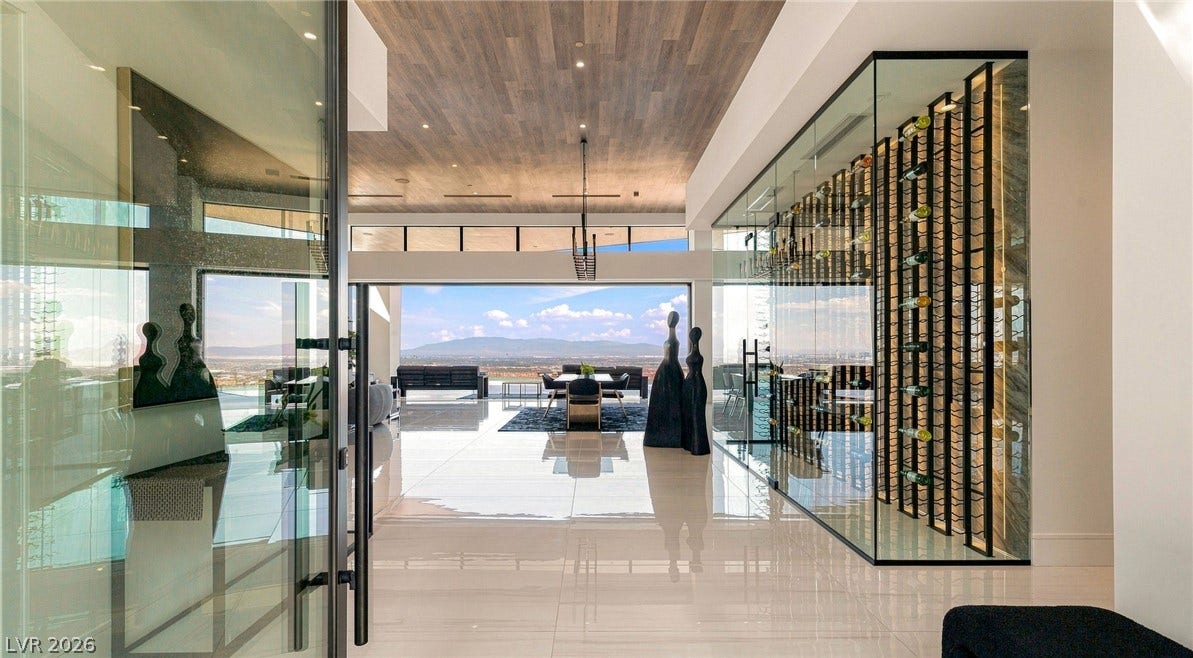 4 Chisel Crest Court, Henderson, NV 89012 Gleaming tile floors lead past a glass-enclosed wine room toward expansive mountain views.