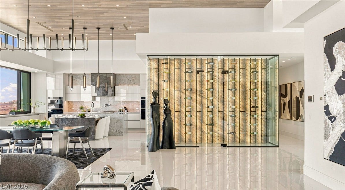 4 Chisel Crest Court, Henderson, NV 89012 Polished tile flooring and high wood-paneled ceilings frame this modern, open-concept living space.