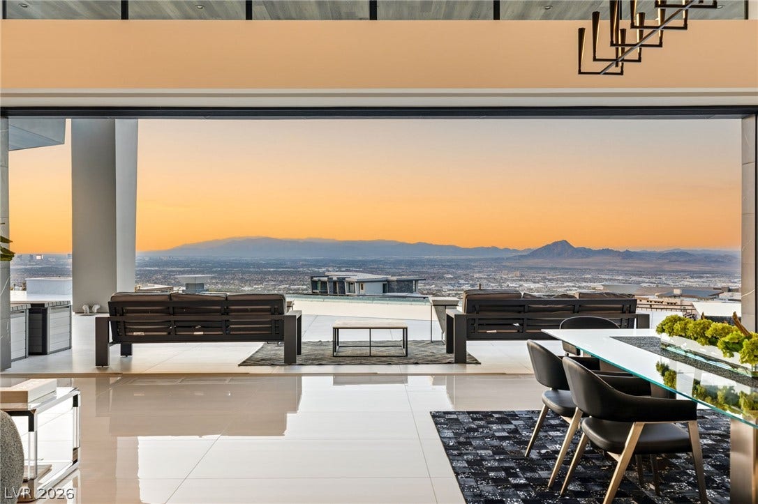 4 Chisel Crest Court, Henderson, NV 89012 Gleaming polished tile floors lead out to sweeping mountain vistas framed by massive glass sliders.