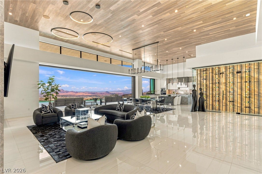 4 Chisel Crest Court, Henderson, NV 89012 Polished tile flooring and rich wood ceilings frame a vast open-concept living area with sweeping desert views.