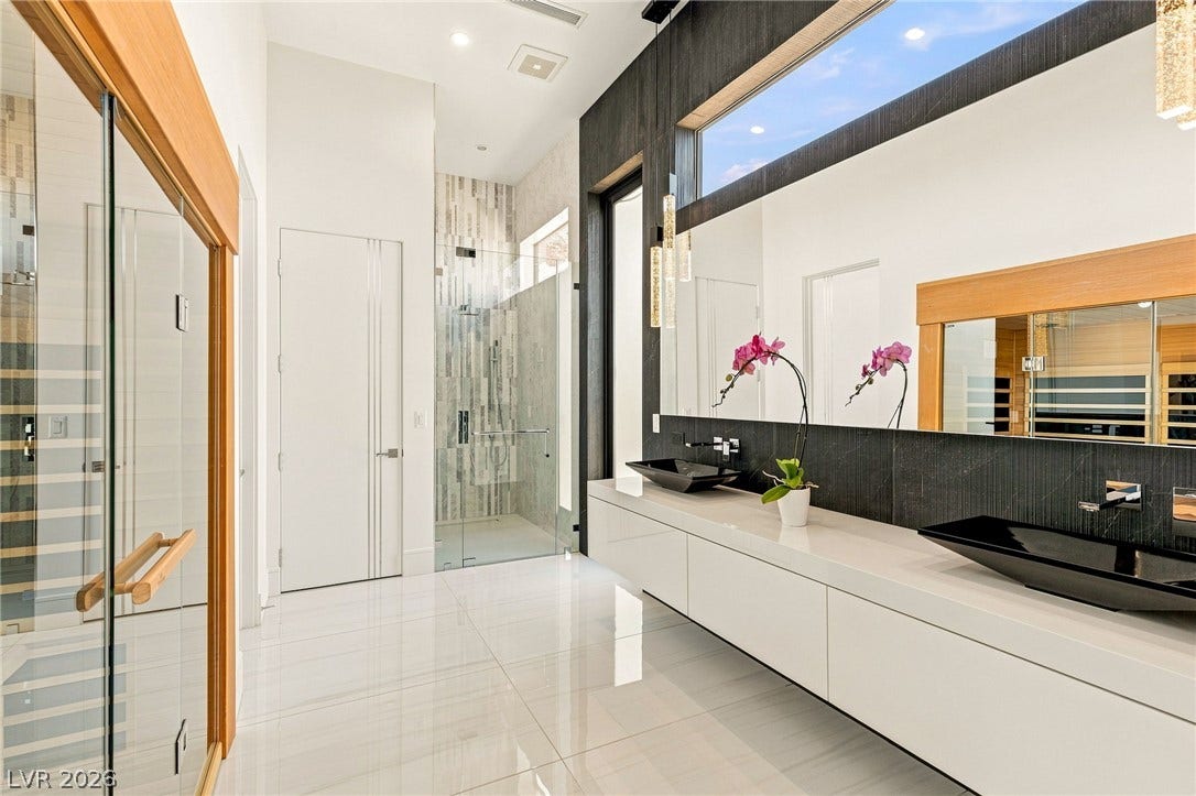 4 Chisel Crest Court, Henderson, NV 89012 Clean lines and high ceilings define this contemporary bathroom with an integrated glass shower.