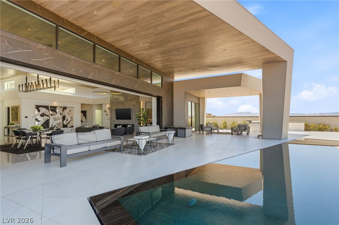4 Chisel Crest Court, Henderson, NV 89012 Seamless indoor-outdoor living merges a covered terrace with a sparkling geometric pool.