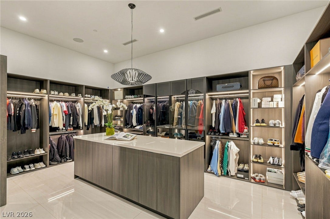 4 Chisel Crest Court, Henderson, NV 89012 Polished tile flooring and integrated lighting elevate this expansive wardrobe space.