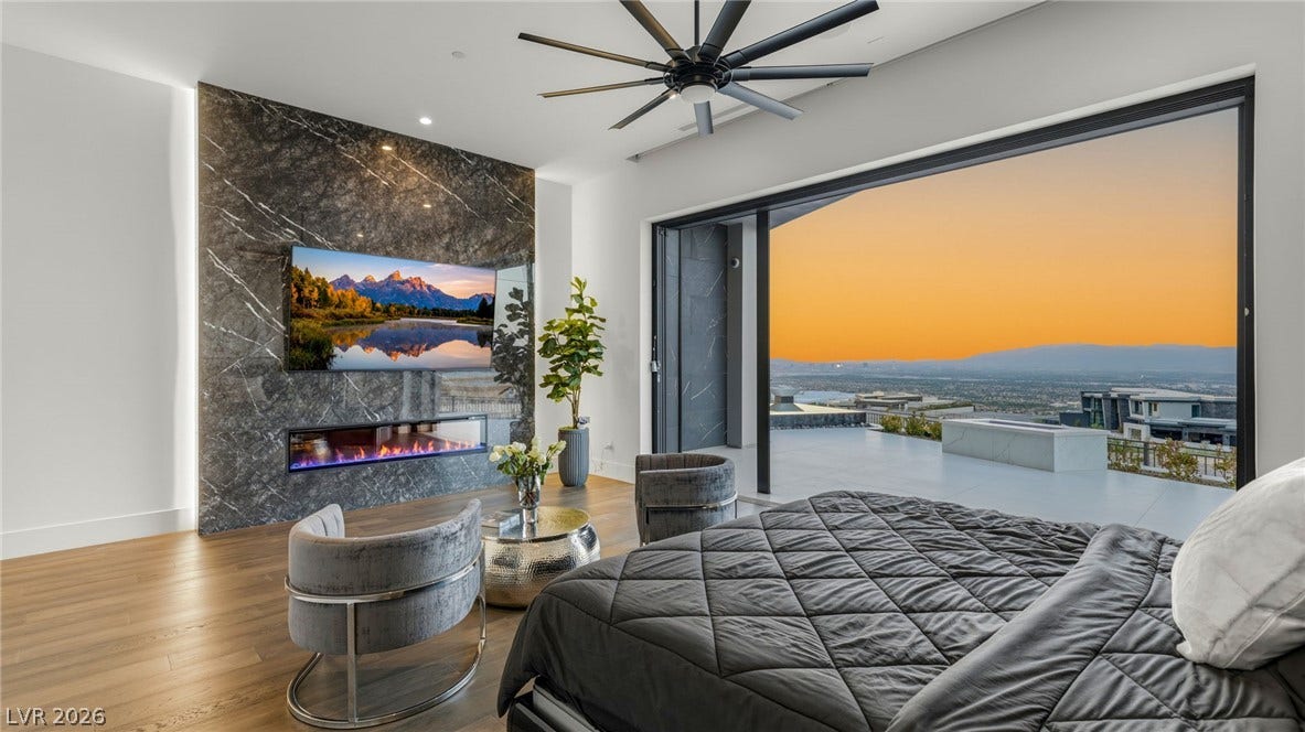 4 Chisel Crest Court, Henderson, NV 89012 Massive sliding glass doors frame panoramic city and mountain views during sunset.