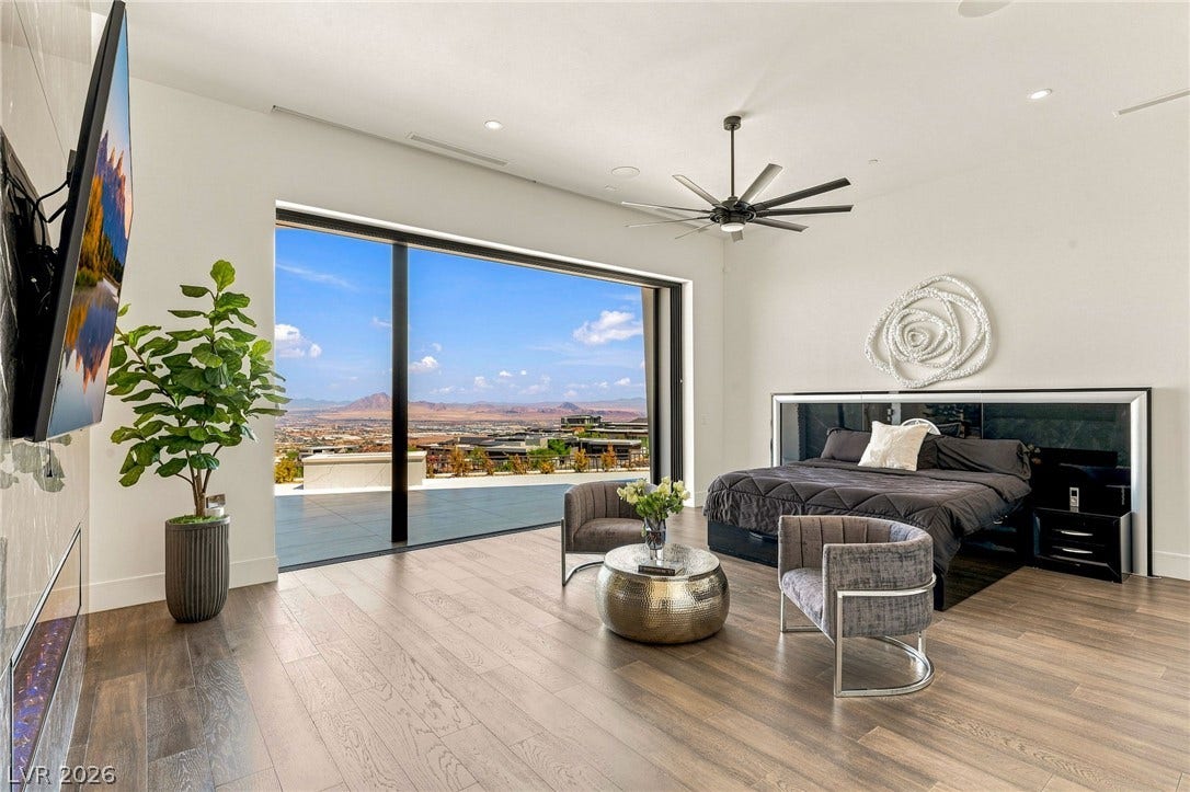 4 Chisel Crest Court, Henderson, NV 89012 Gleaming wood floors and floor-to-ceiling glass doors define this refined bedroom retreat.