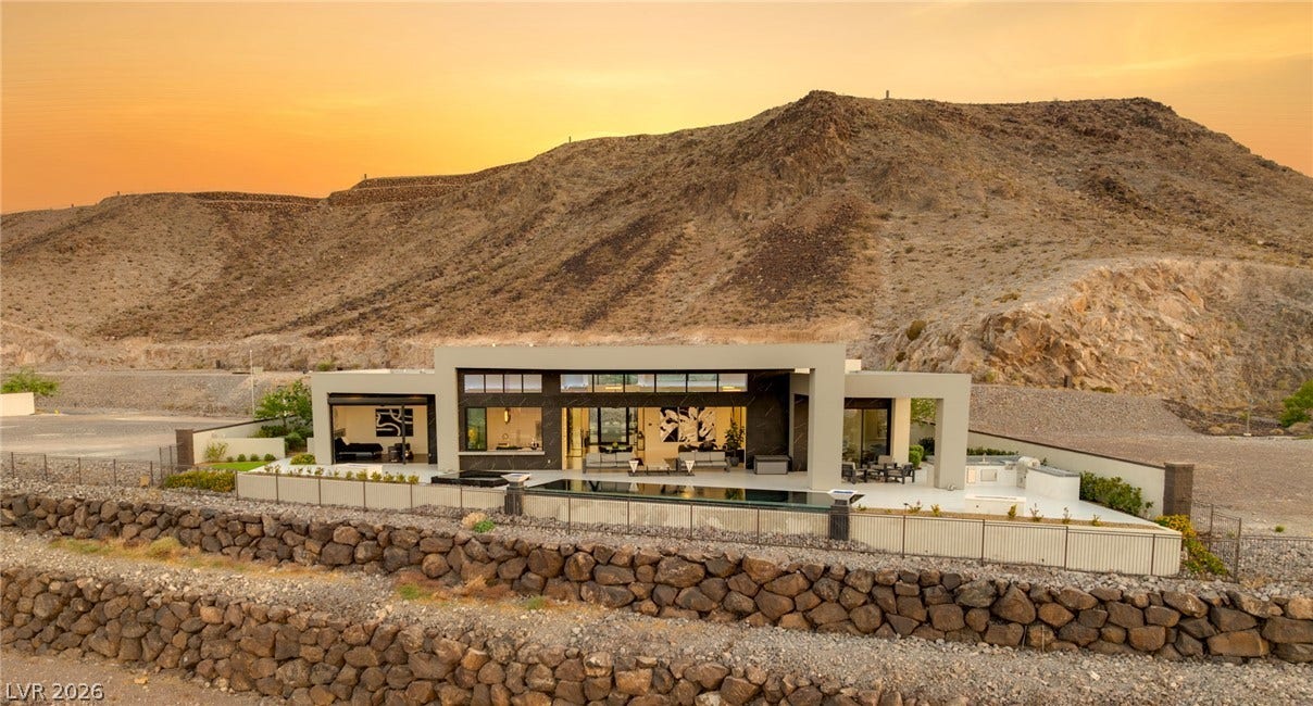 4 Chisel Crest Court, Henderson, NV 89012 Dramatic mountain backdrops frame this modern desert estate featuring sleek architecture and an infinity pool.