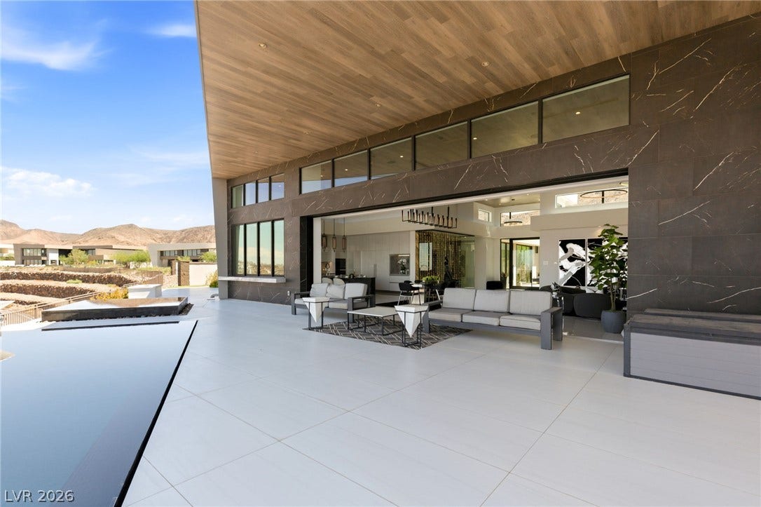 4 Chisel Crest Court, Henderson, NV 89012 Seamless indoor-outdoor transitions define this covered terrace featuring wood-plank ceilings and stone-clad walls.