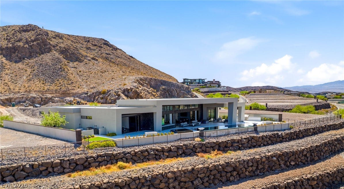 4 Chisel Crest Court, Henderson, NV 89012 Bold modern architecture commands attention against a rugged desert mountain backdrop.