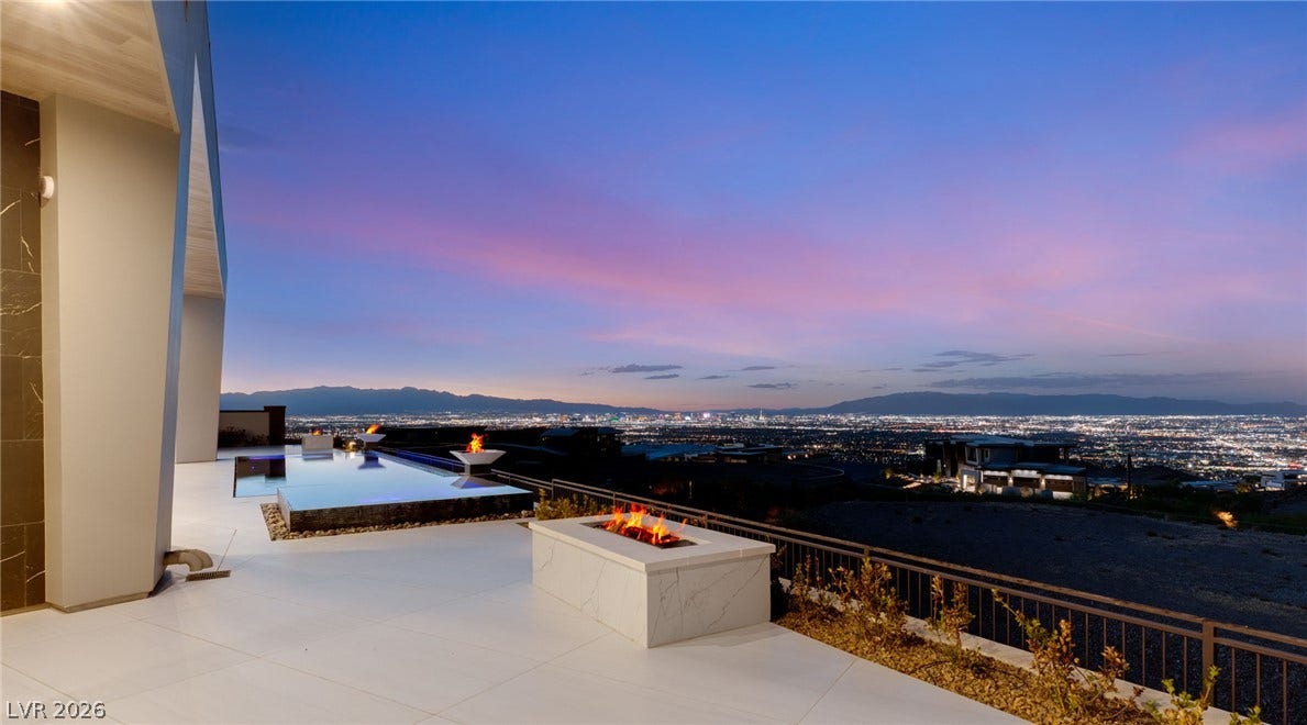 4 Chisel Crest Court, Henderson, NV 89012 Glittering city lights provide a dramatic backdrop for the streamlined patio and fire feature.