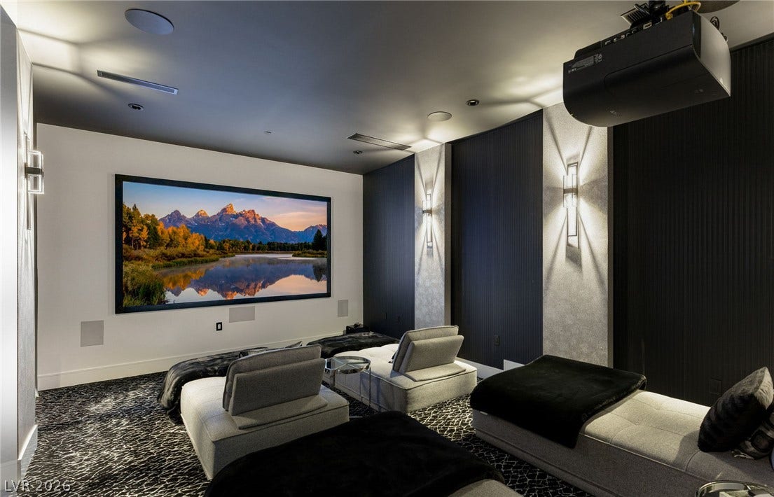 4 Chisel Crest Court, Henderson, NV 89012 A dedicated home theater room provides a private cinema experience with custom wall lighting and textured carpet.