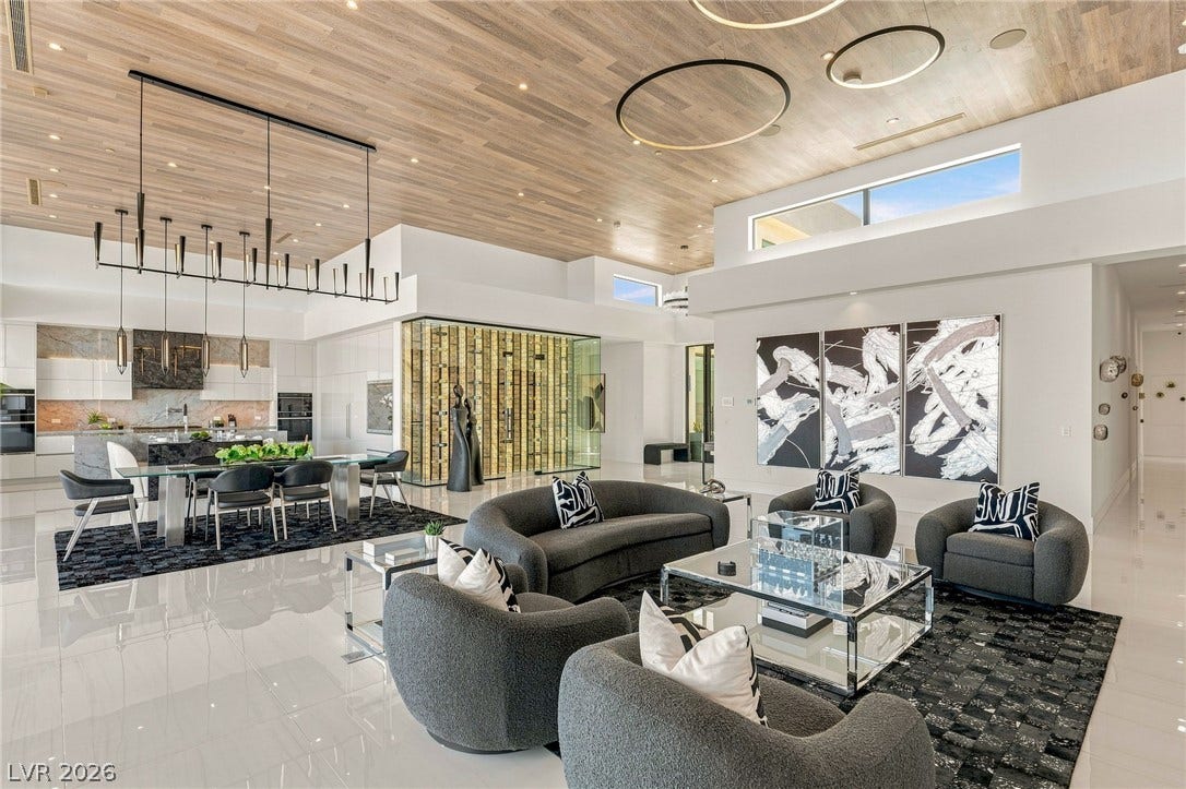 4 Chisel Crest Court, Henderson, NV 89012 Polished tile flooring and rich wood-plank ceilings define this grand, open-concept living space.