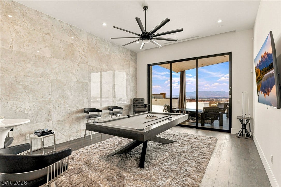 4 Chisel Crest Court, Henderson, NV 89012 Polished tile accents and glass doors framing scenic mountain vistas define this modern recreation space.
