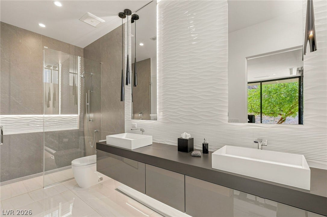 4 Chisel Crest Court, Henderson, NV 89012 Clean lines and modern surfaces define this contemporary primary bath with dual vessel sinks.