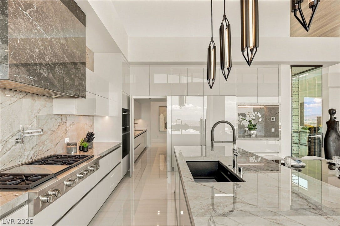 4 Chisel Crest Court, Henderson, NV 89012 Polished tile flooring and marble countertops elevate this modern culinary space.